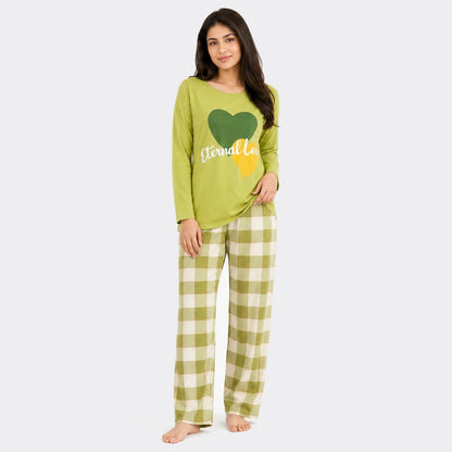 Woman wearing a green pajama set with a heart design on a white background