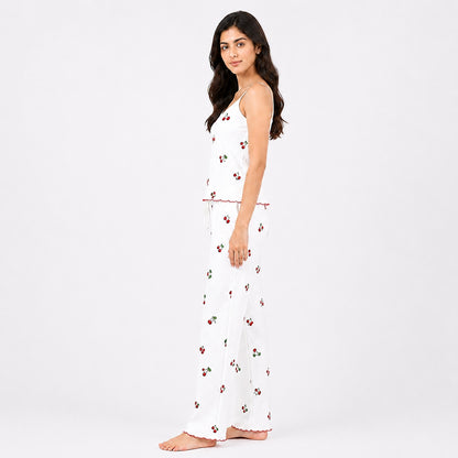 Woman wearing a white dress with red floral patterns on a white background